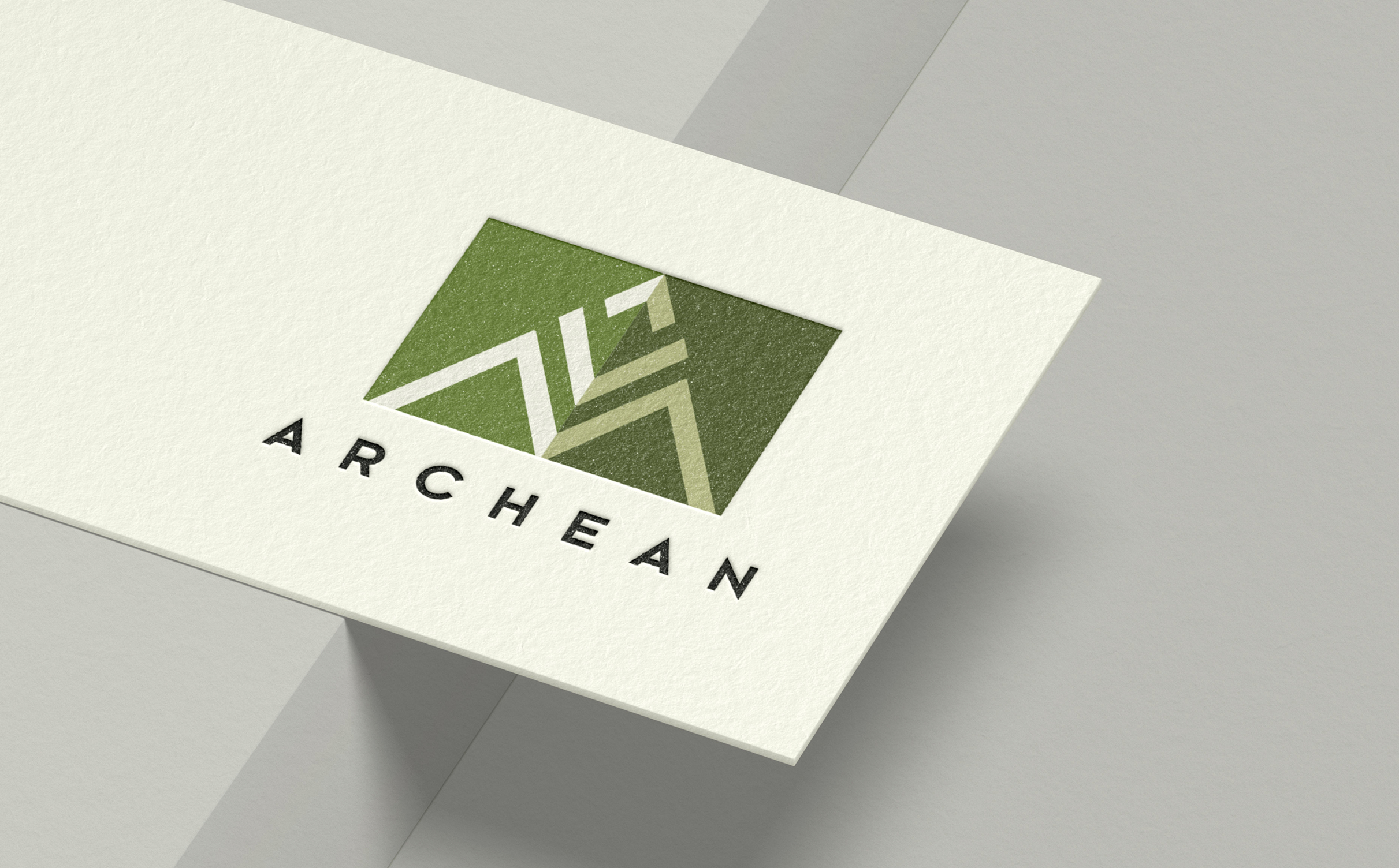 A business card with a green geometric mountain logo and the text "ARCHEAN" below, conveying a modern and professional tone.