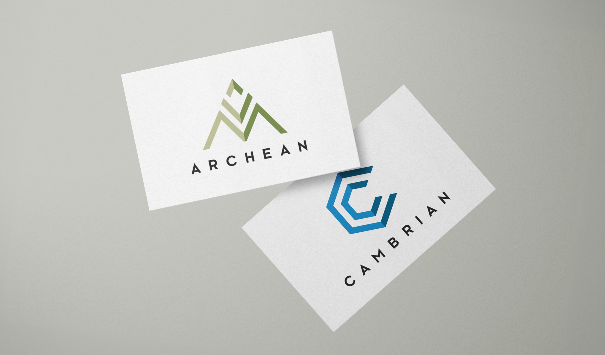 Two business cards on a gray background; one features a green triangular logo with "Archean", the other has a blue geometric "C" with "Cambrian".