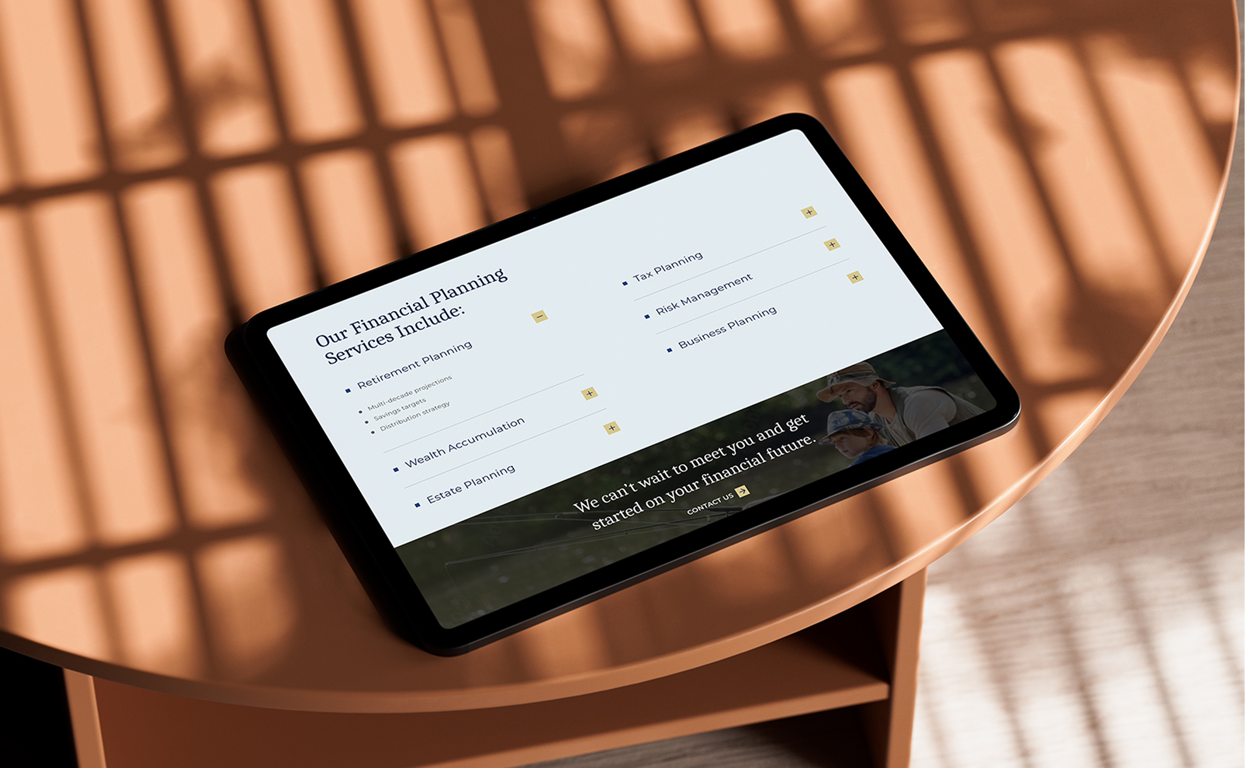Faubourg-iPad-Horizontal Tablet on a sunlit wooden table displays a section of the Faubourg Private Wealth website. Services listed include retirement planning, risk management, and estate planning. Warm ambiance.
