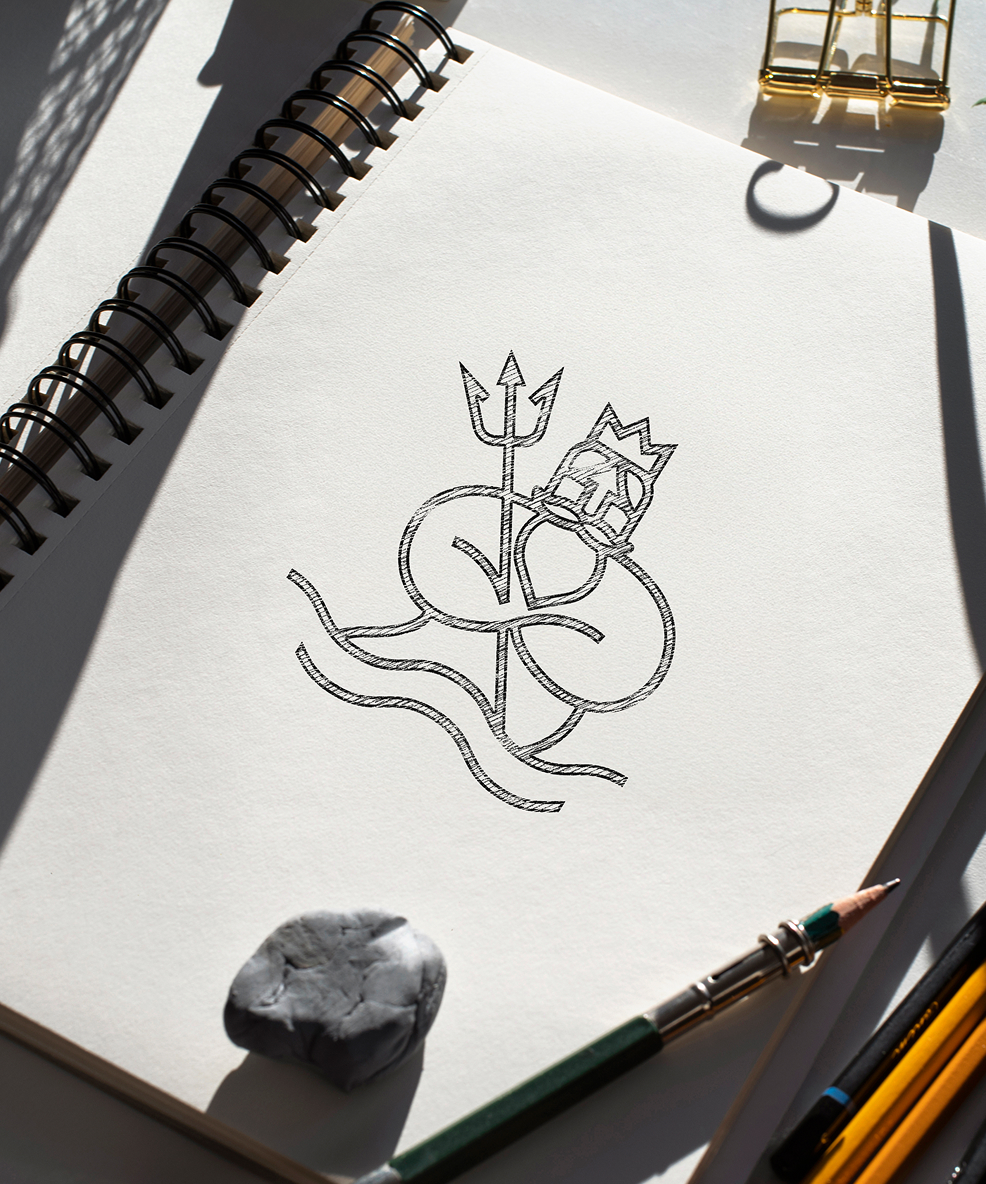 A sketchbook page shows a stylized drawing of Neptune holding a trident. The page is lit warmly, with shadows. Nearby are pencils and an eraser.