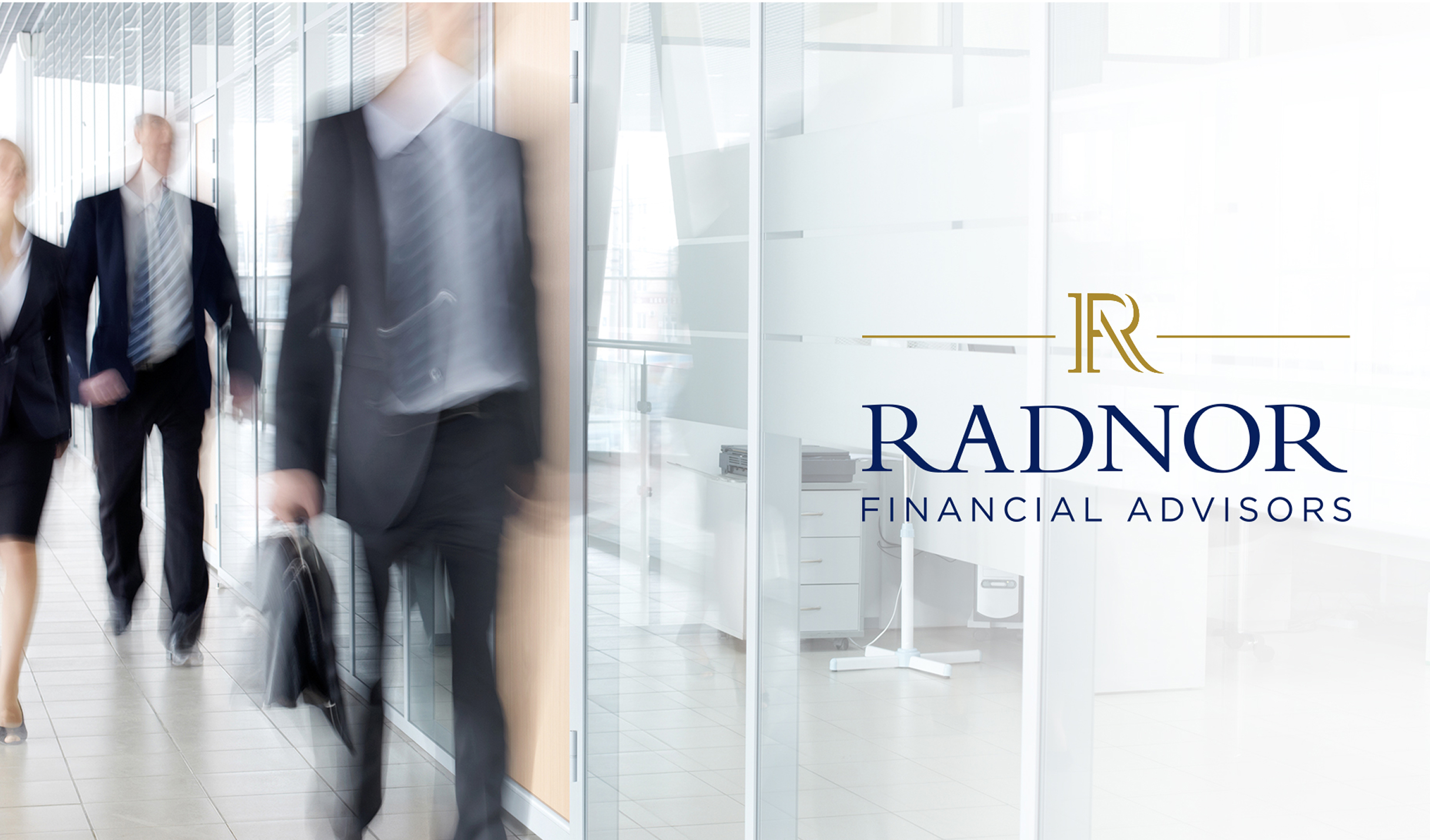 Three business professionals in formal attire walk briskly through a modern office with glass walls. Radnor Financial Advisors logo on the right.