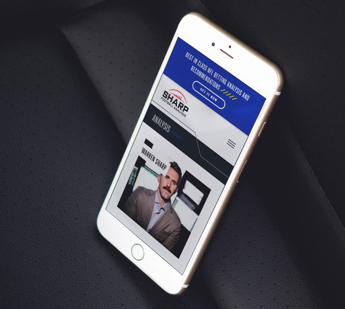 Smartphone displaying a sports analysis website with a headline banner. The site features a man's portrait, suggesting expertise in sports betting analysis.