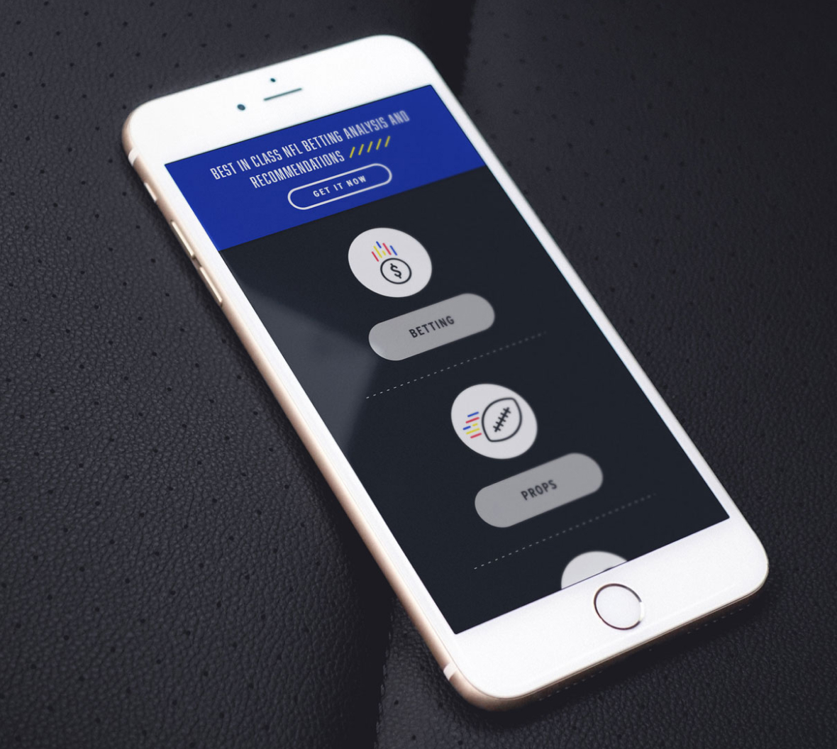 Smartphone on a black textured surface displaying a web page with options for "Betting" and "Props," and a header promoting betting analysis services.