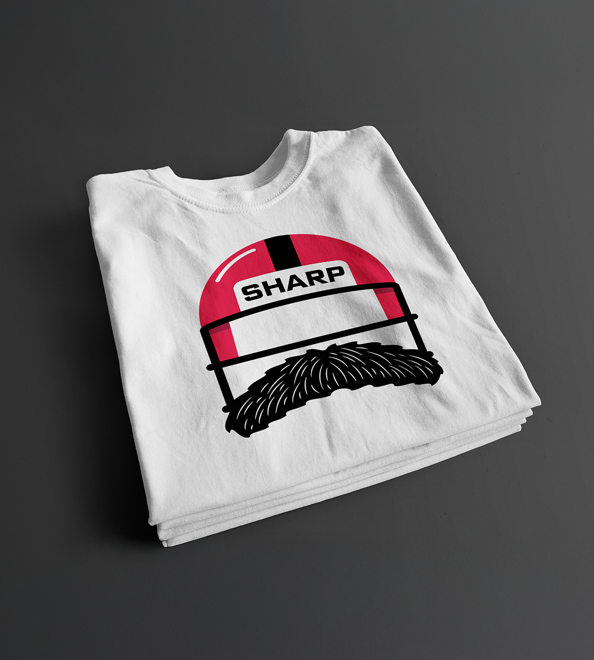 White t-shirt neatly folded, displaying a graphic of a red and black football helmet with "SHARP" text and a mustache design underneath.