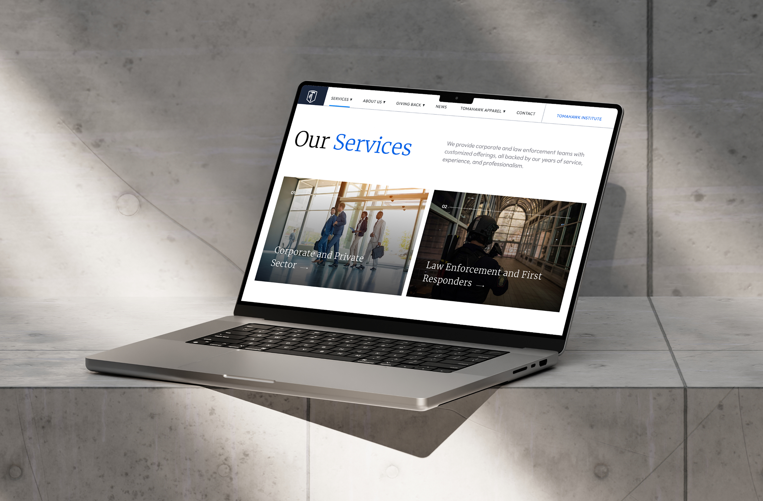 Tomahawk-Laptop A laptop displaying a page from the Tomahawk website titled "Our Services" showing sections for Corporate, Private Sector, and Law Enforcement. The laptop rests on a concrete surface.