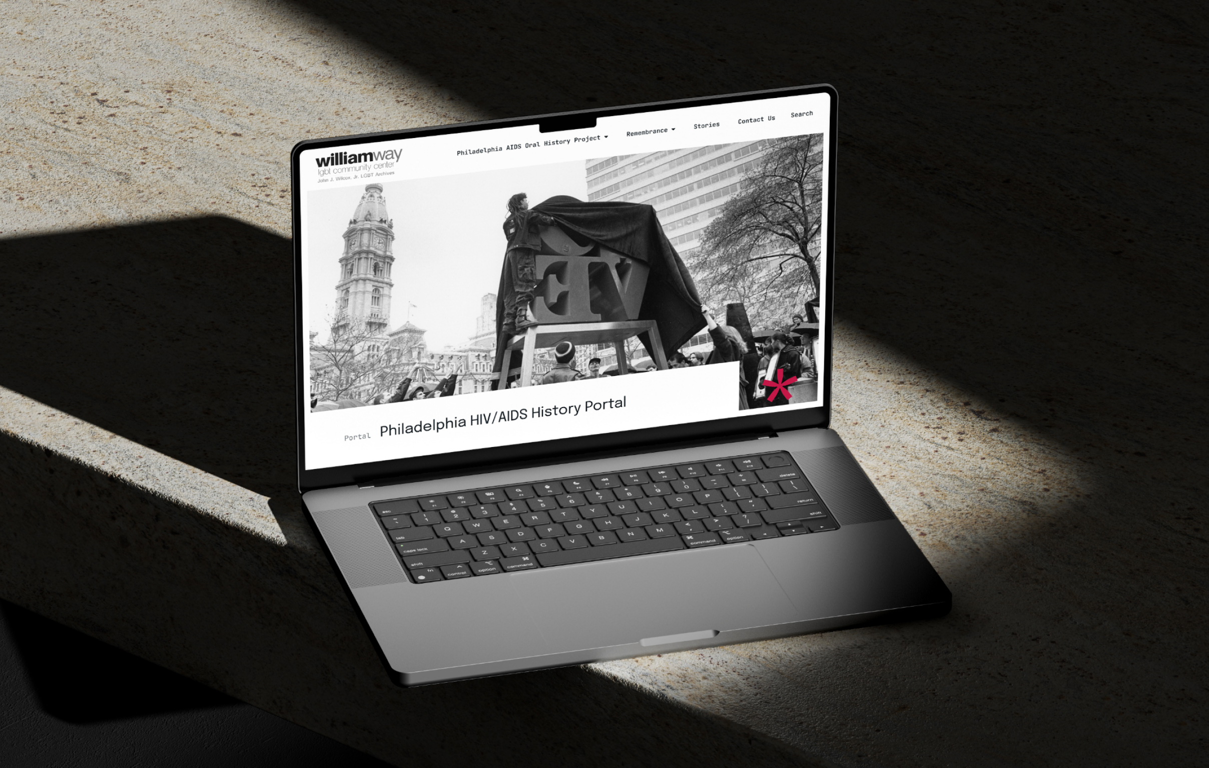 A laptop displaying the WayGay website titled "Philadelphia HIV/AIDS History Portal" with a historic city scene, conveying an informative and educational tone.