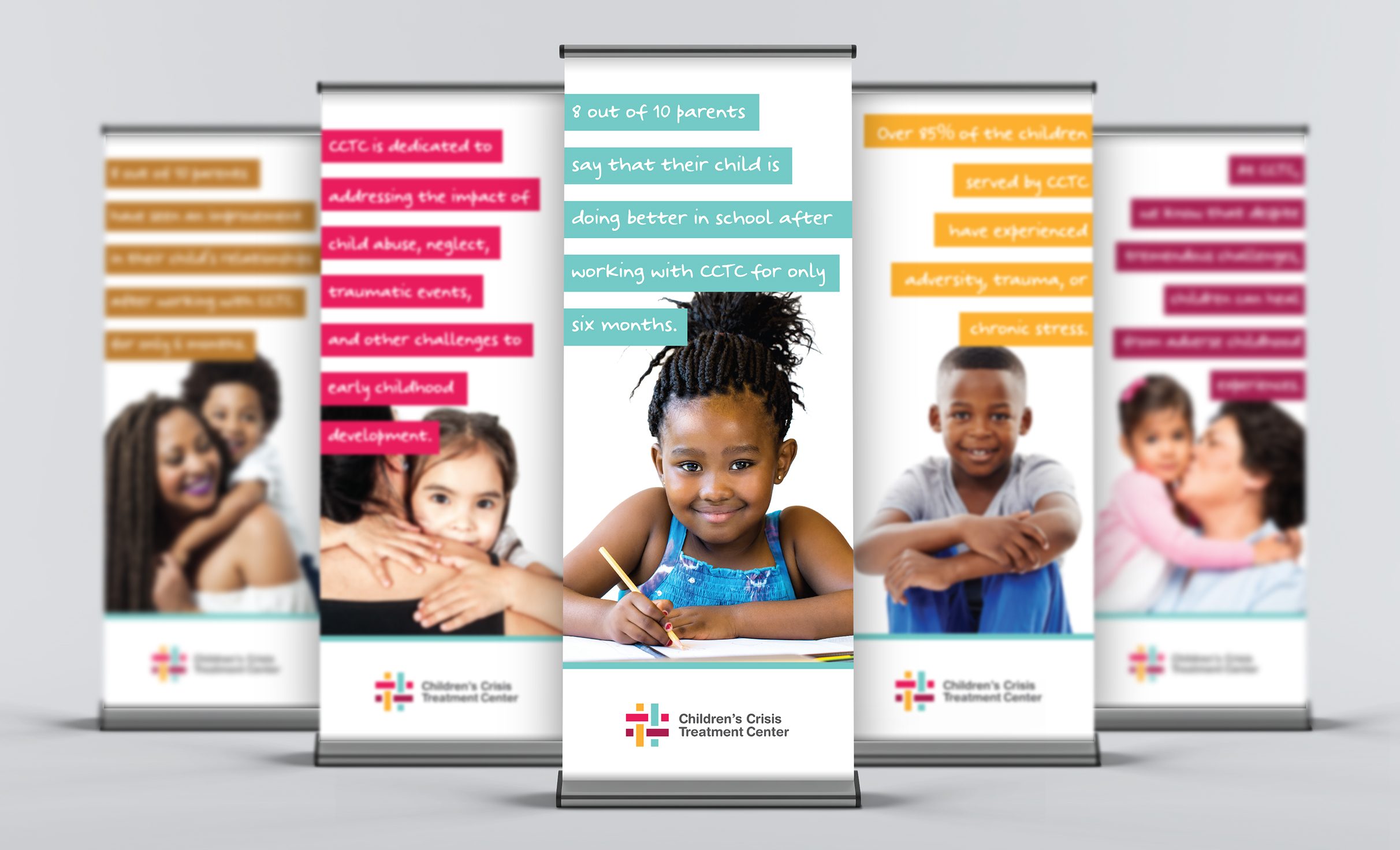 Five standing banners display smiling children and messages about the Children's Crisis Treatment Center's impact on education and child well-being. The tone is hopeful and supportive.