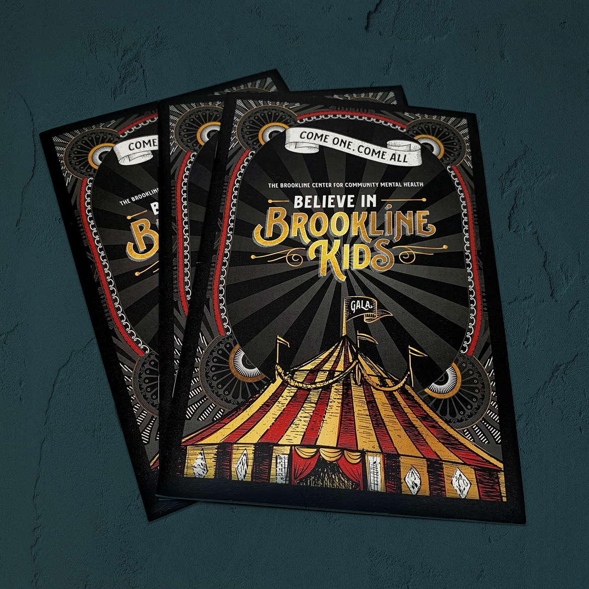 Vintage-style ornate border surround a circus-themed invitation with a red and gold circus tent, saying “Believe in Brookline Kids.”