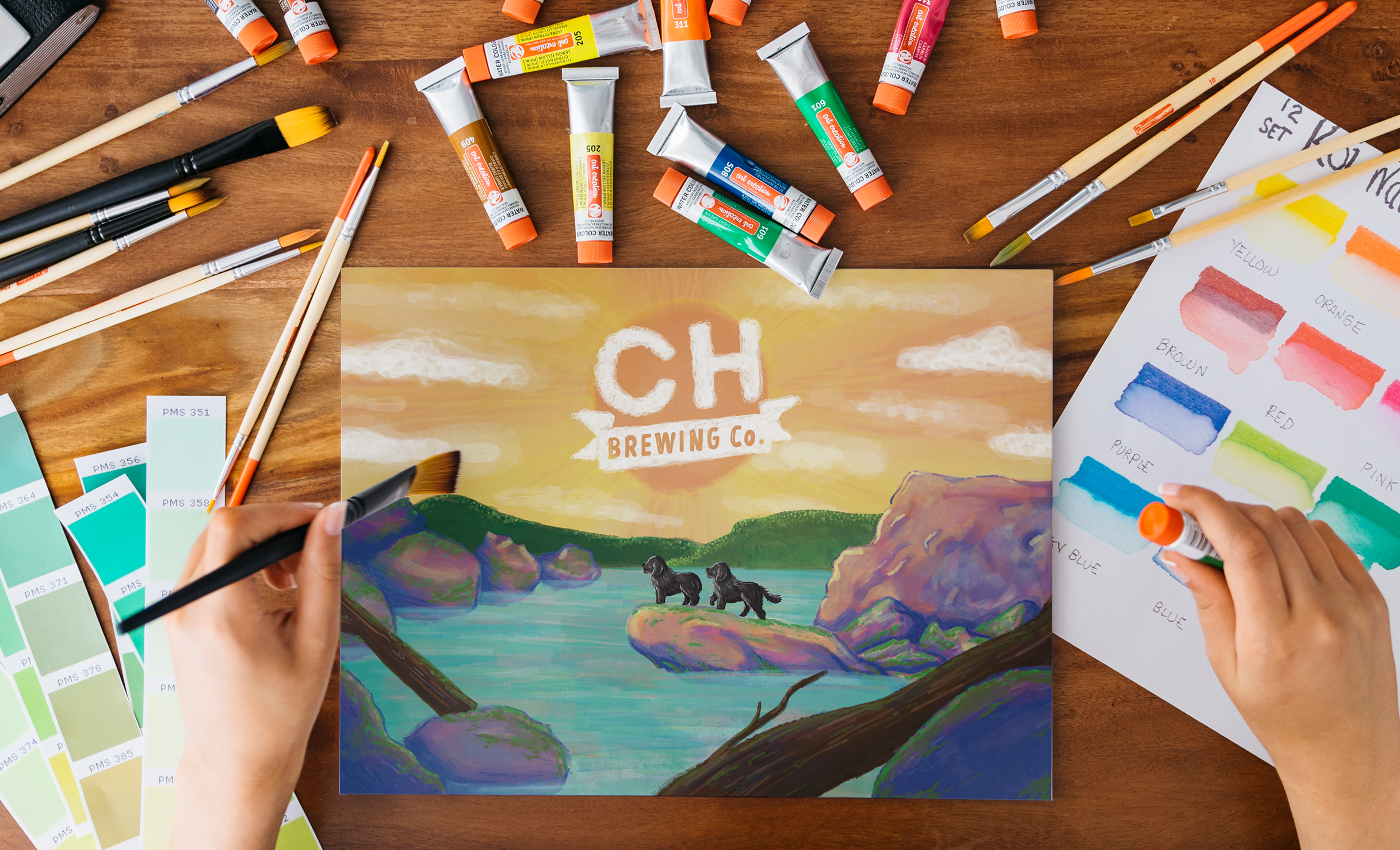 A person paints a scenic landscape with dogs by a river, surrounded by art supplies like brushes and paints. The scene includes a "CH Brewing Co." logo.