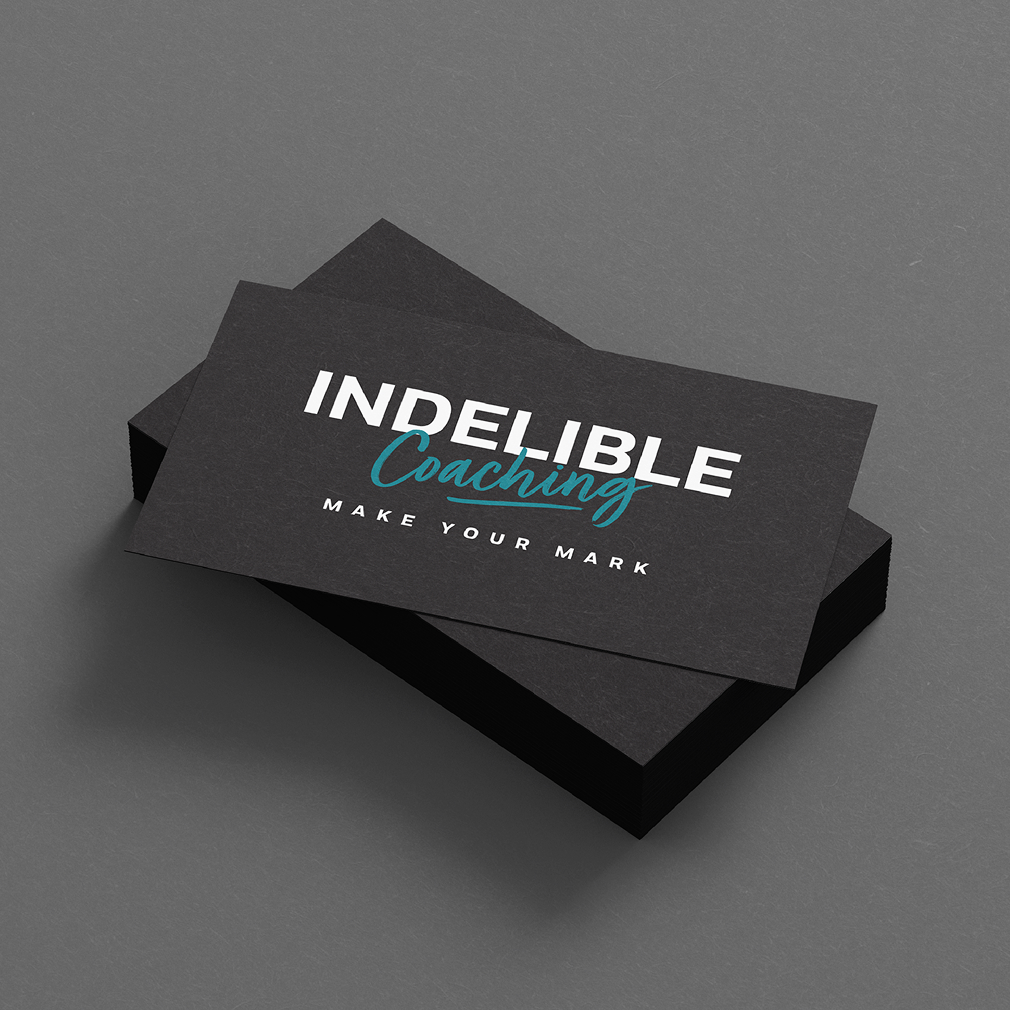 IndelibleCoaching-BusinessCards A stack of elegant black business cards with the Indelible Coaching logo. The logo includes white text "INDELIBLE" and turquoise script "Coaching" slightly overlapping underneath. Tagline text reads "MAKE YOUR MARK" in white below.