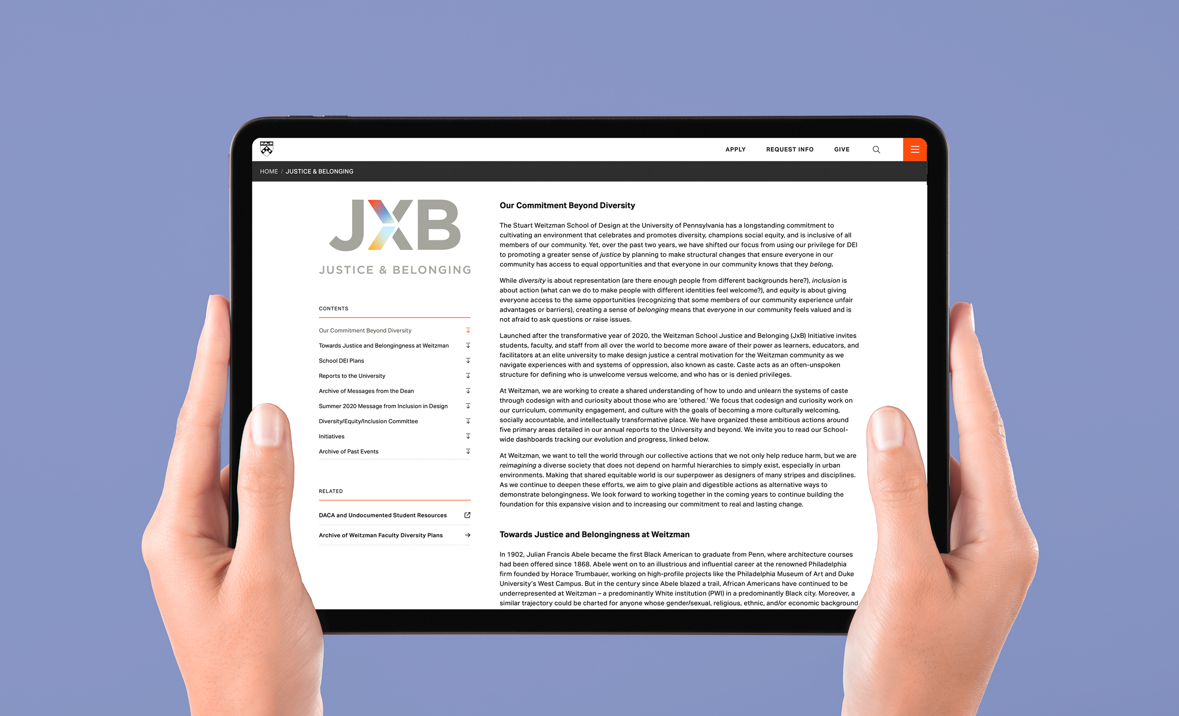 Two hands hold a tablet displaying a webpage titled "Justice & Belonging." The page contains text on diversity commitment. The background is light blue.