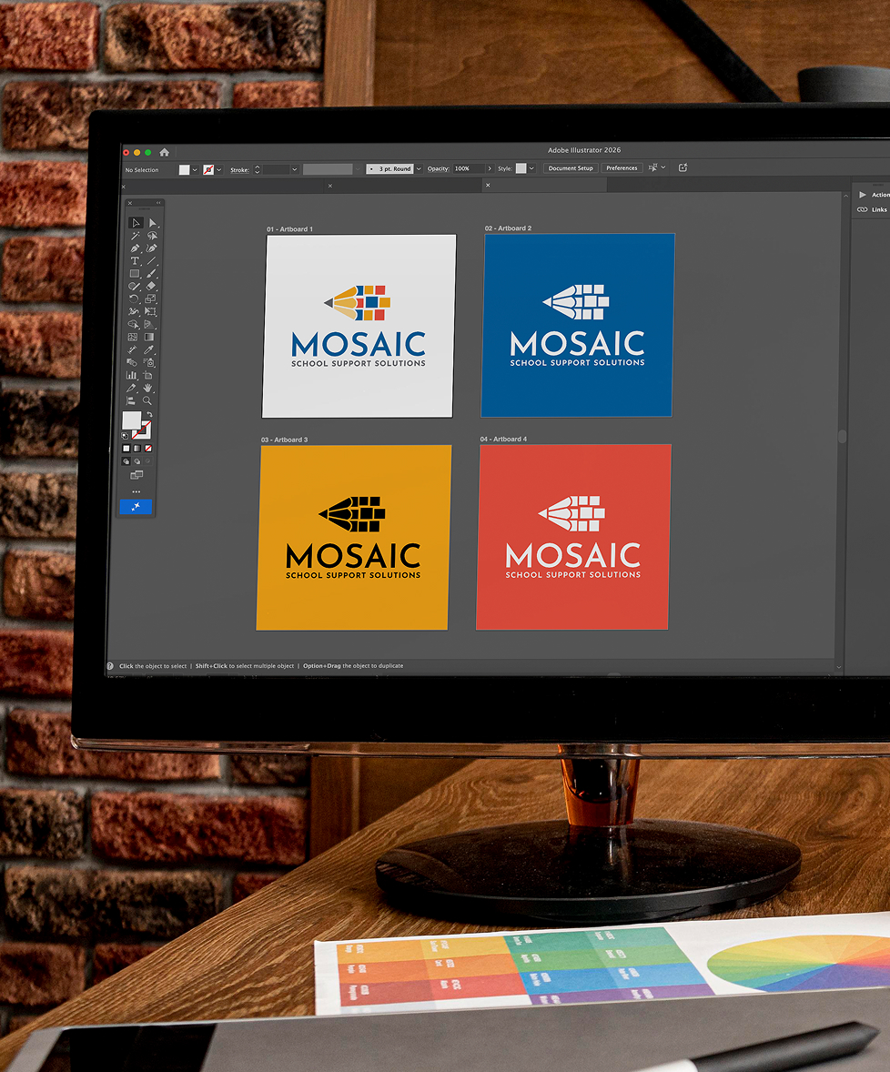 A computer screen displays design software with four squares, one is white, one is blue, one is yellow, and one is red. "MOSAIC School Support Solutions" logos show in different color schemes. The background is a brick wall and wooden desk, with a color palette printout nearby.